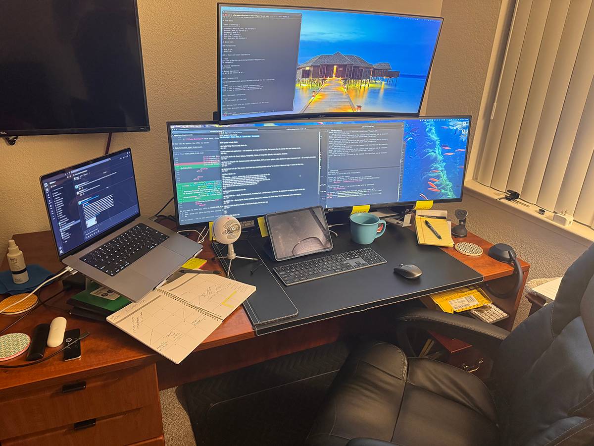 Michael's workspace: multi-monitor development setup with code editors and notes